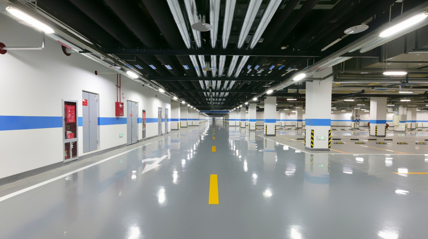 Finished grey epoxy floor in a basement car park with line markings