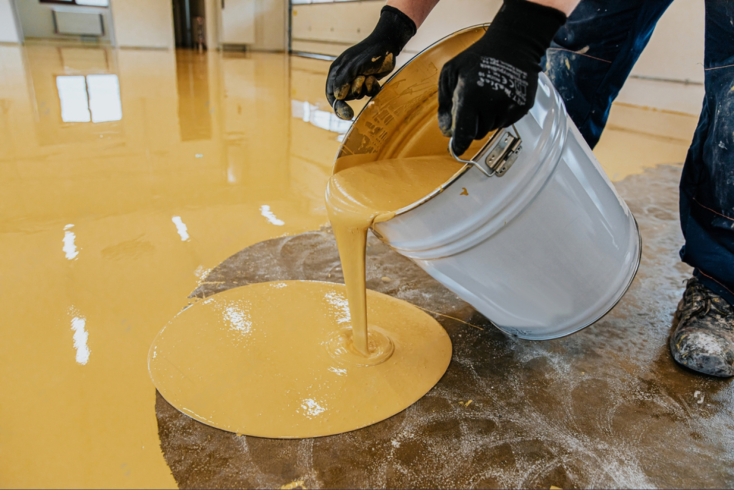 Self-levelling epoxy being poured on site by the Vulcan Elastolan flooring team
