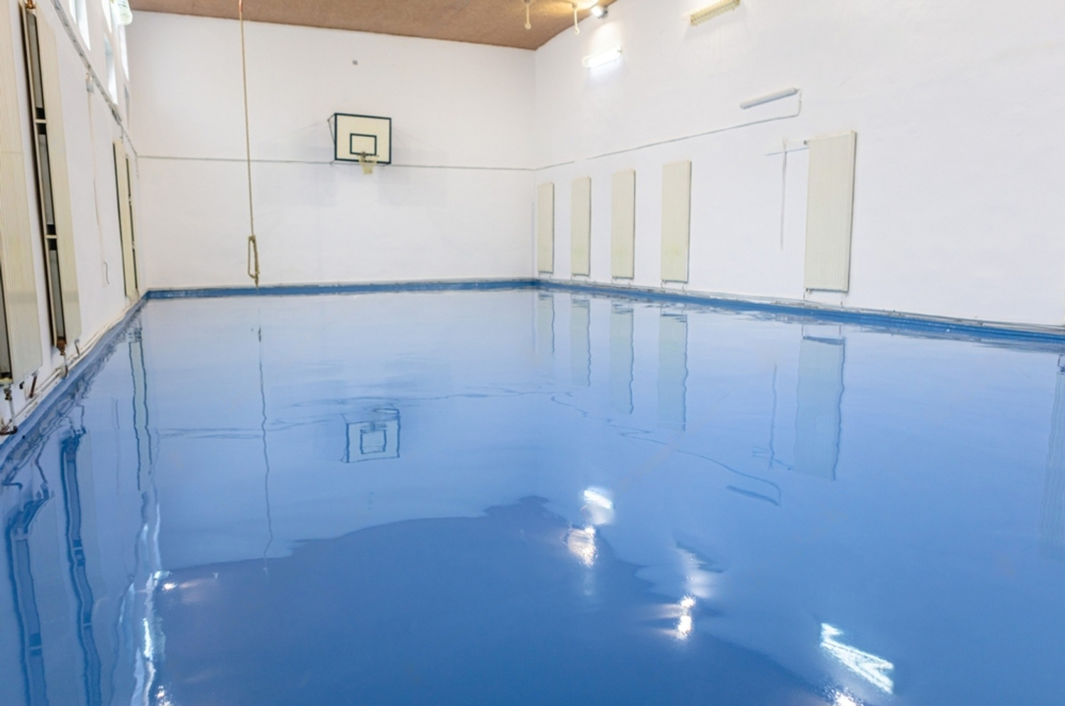 Finished blue epoxy self-level floor in an indoor sports hall